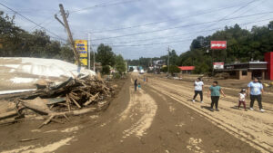 Residents observing the aftermath of Hurricane Helene near Biltmore Village in Asheville, N.C.